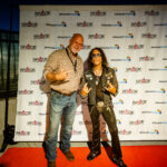 Two people posing on red carpet