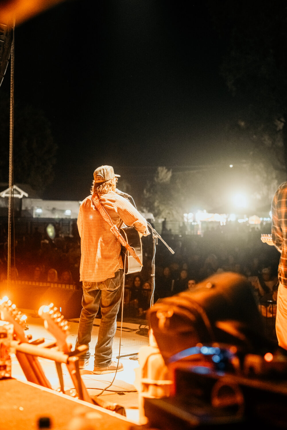 Guitarist performing on outdoor night stage